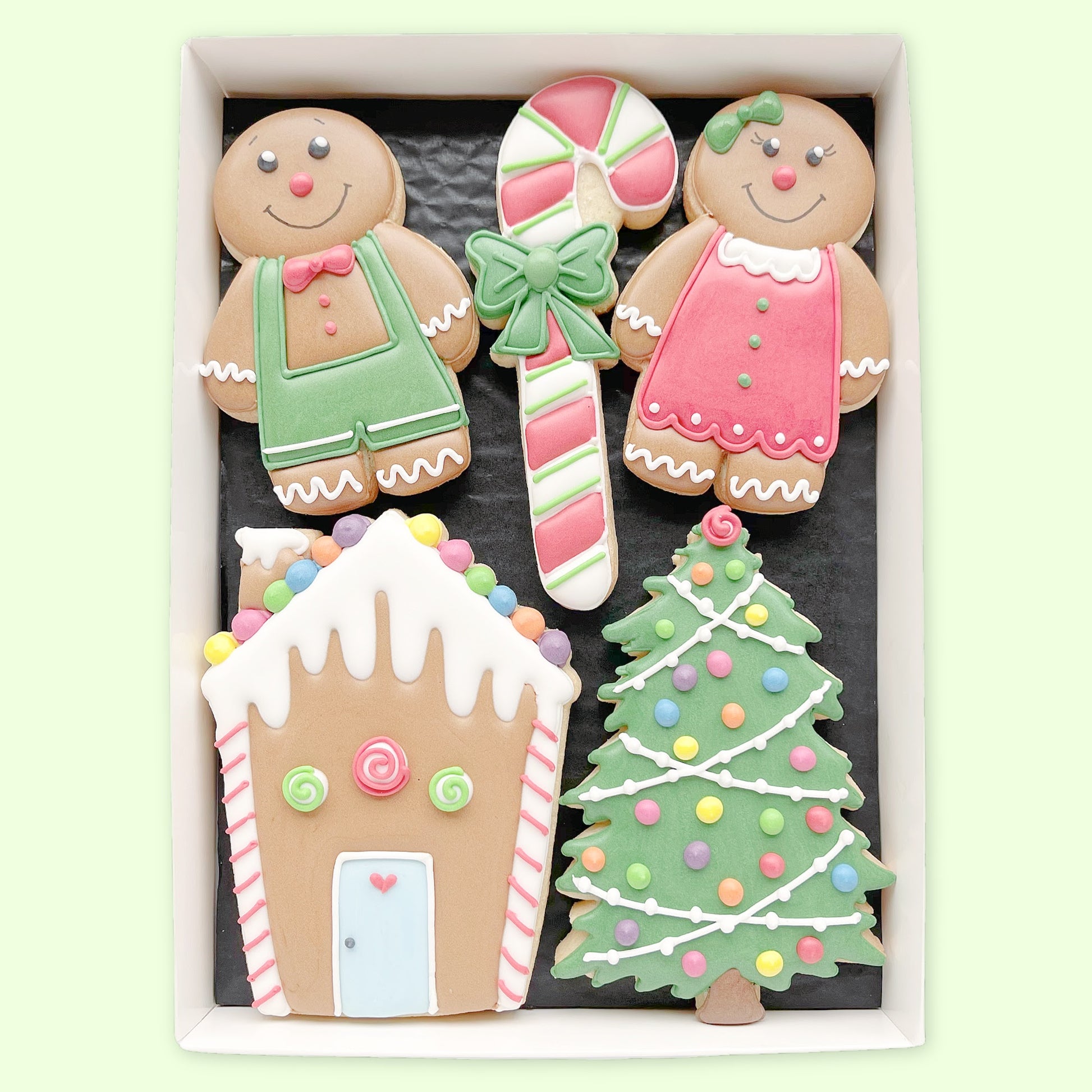 Hand iced gingerbread house boy and girl biscuits by Katie's biscuit shop in an open white gift box