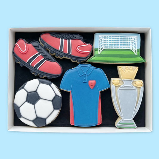 Football themed hand iced biscuits in an open white gift box by Katie's biscuit shop