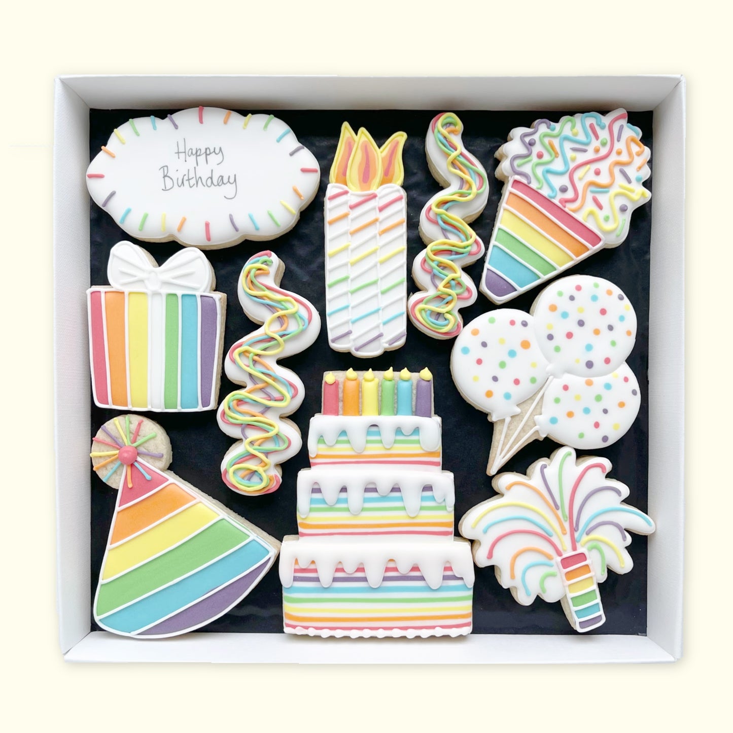 Rainbow happy birthday hand iced biscuits by Katie's Biscuit shop in an open white gift box