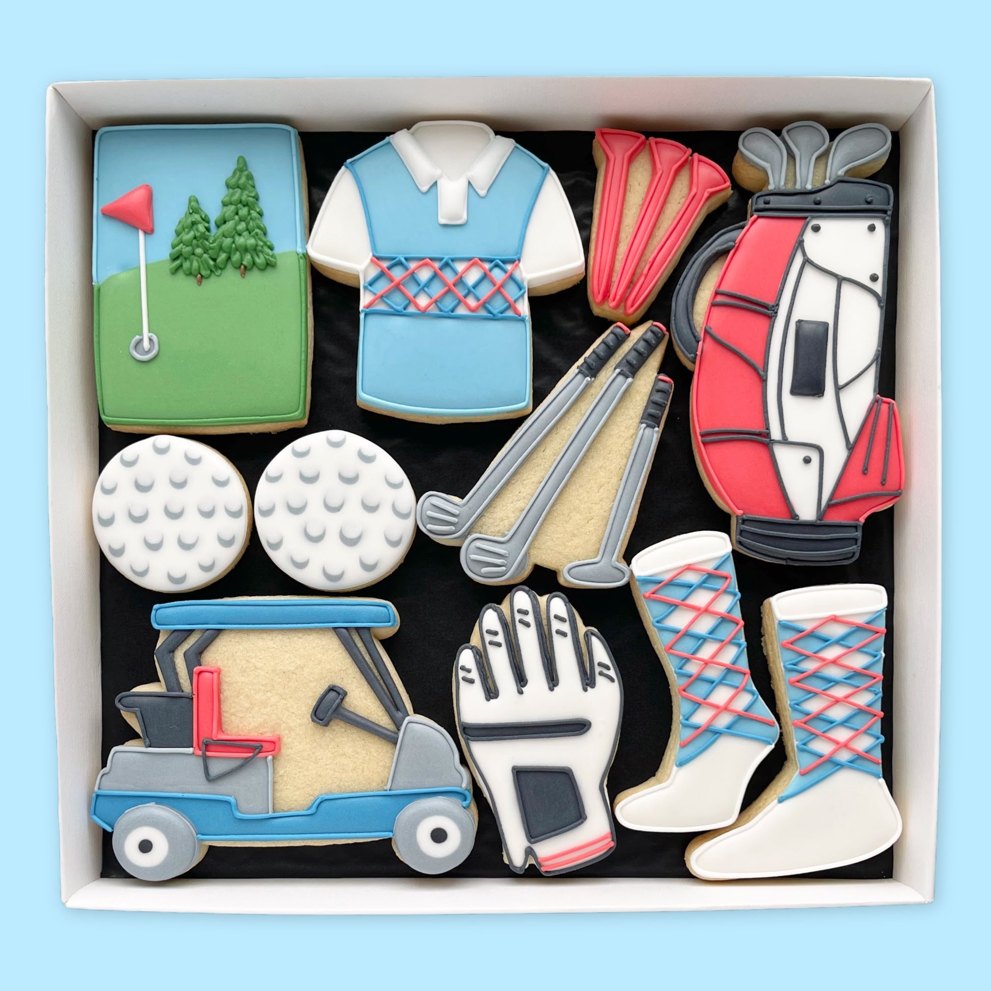 Hand iced golf themed biscuits in an open white gift box by Katie's biscuit shop