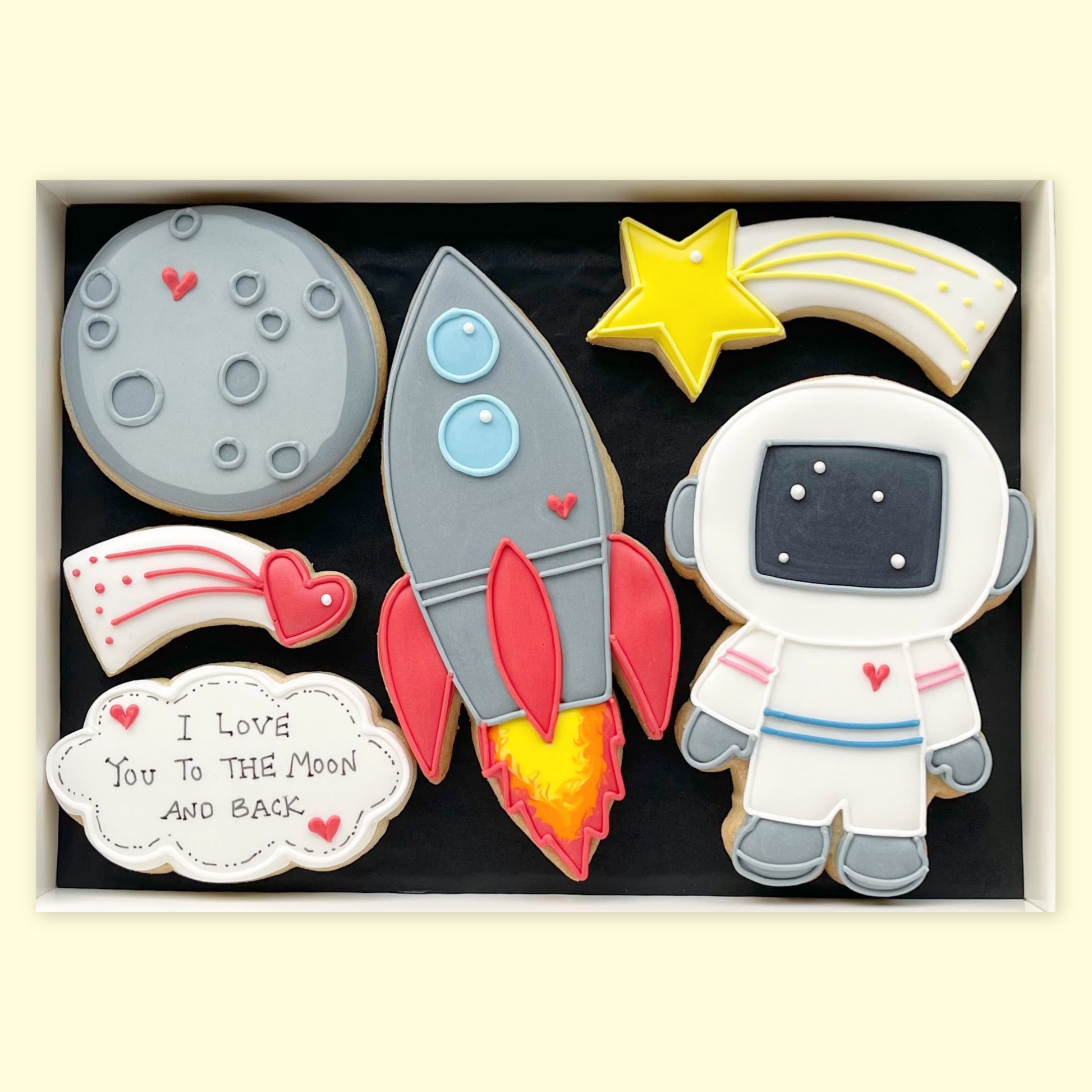I love you to the moon and back themed hand iced biscuits in an open white gift box by Katie's Biscuit Shop