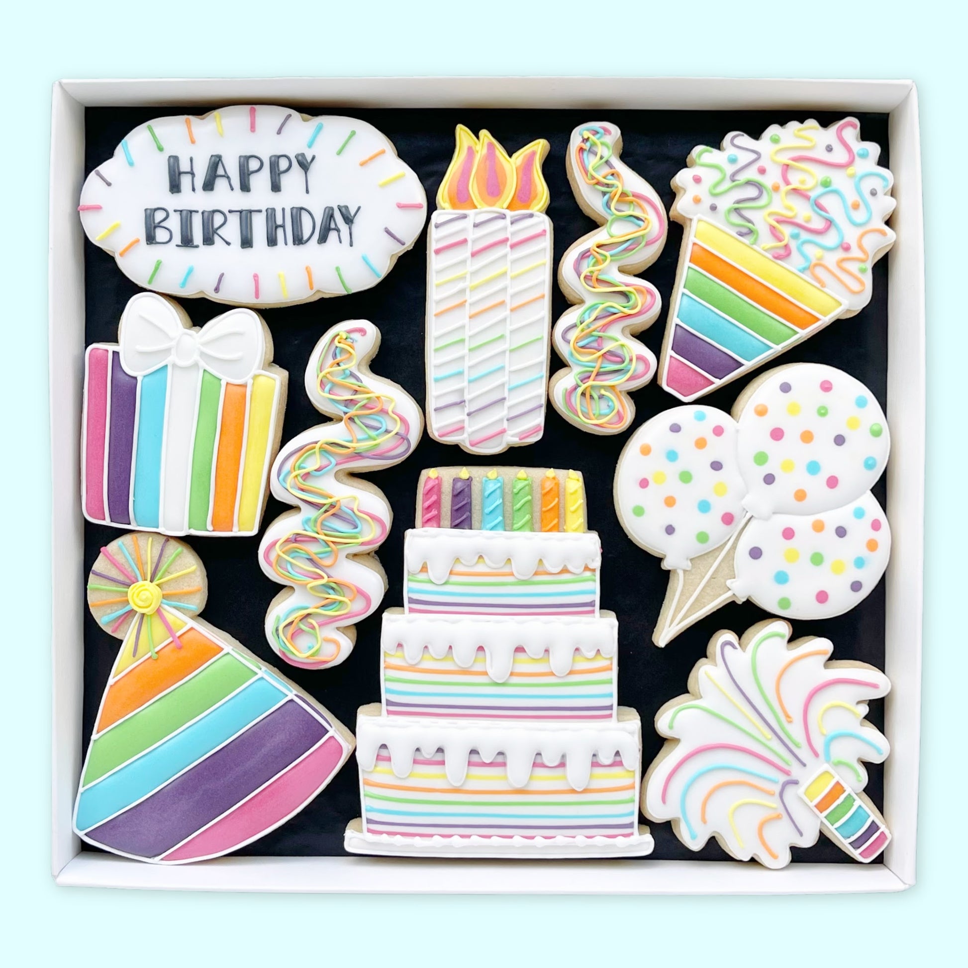Rainbow happy birthday hand iced biscuits by Katie's Biscuit shop in an open white gift box 