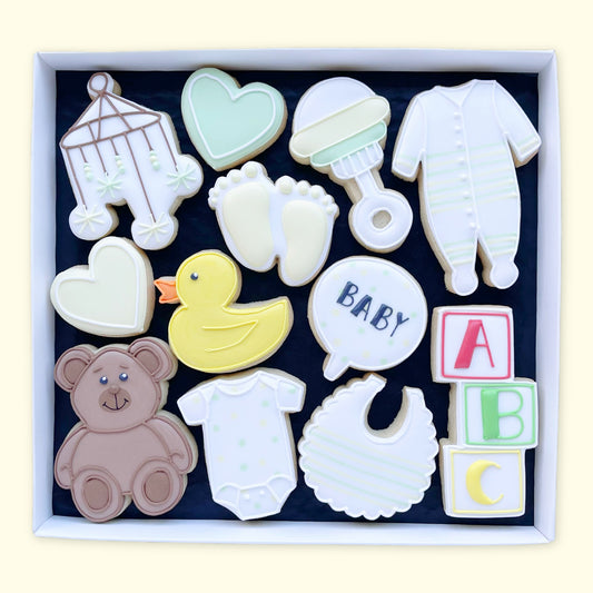 New baby themed hand iced biscuits by Katie's biscuit shop in an open white gift box 