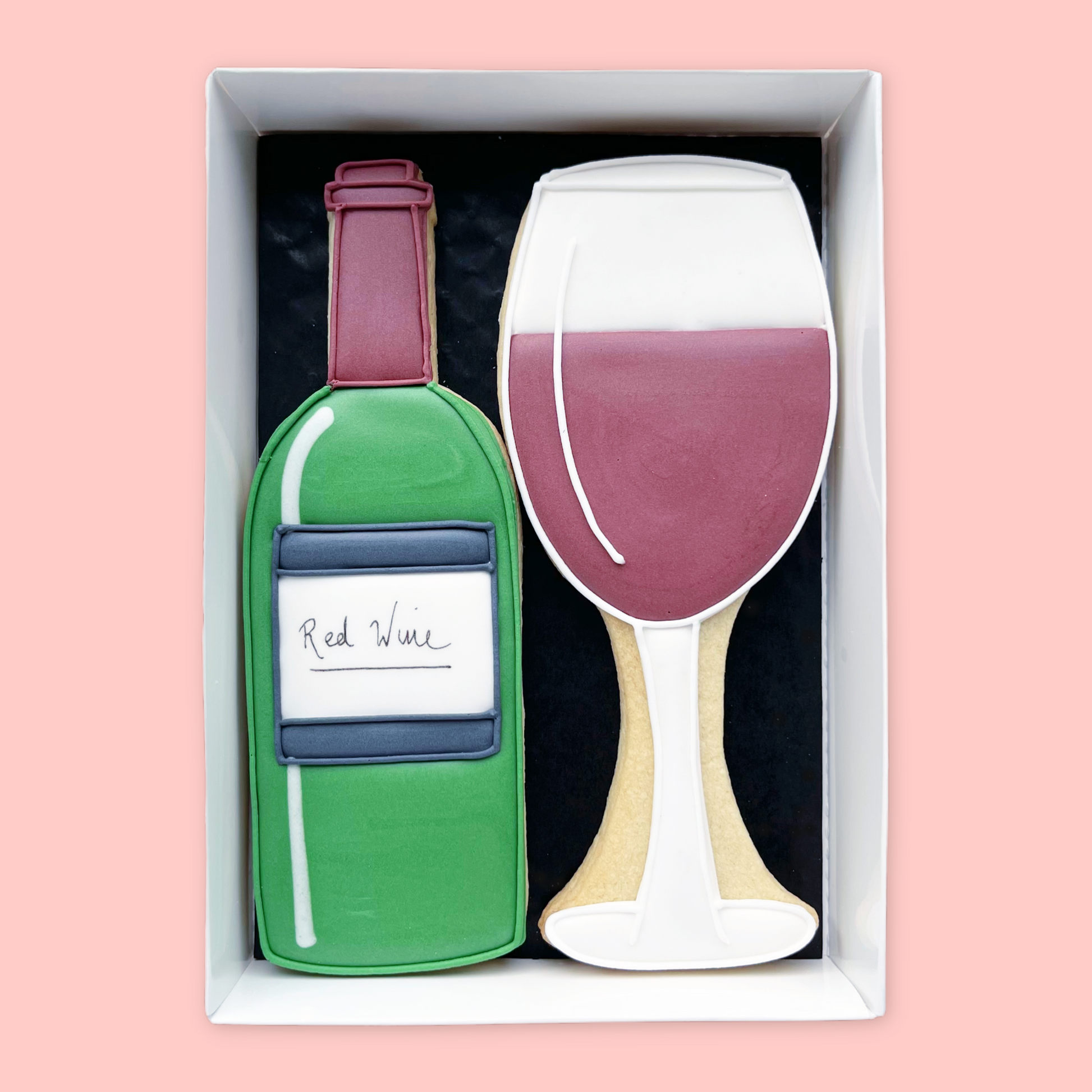 hand iced bottle of red wine with glass biscuits in an open white gift box by katie's biscuit shop