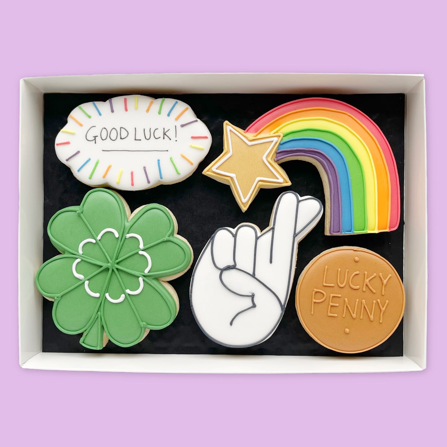 Hand iced Good luck themed biscuits in an open white gift box by Katie's Biscuit shop 