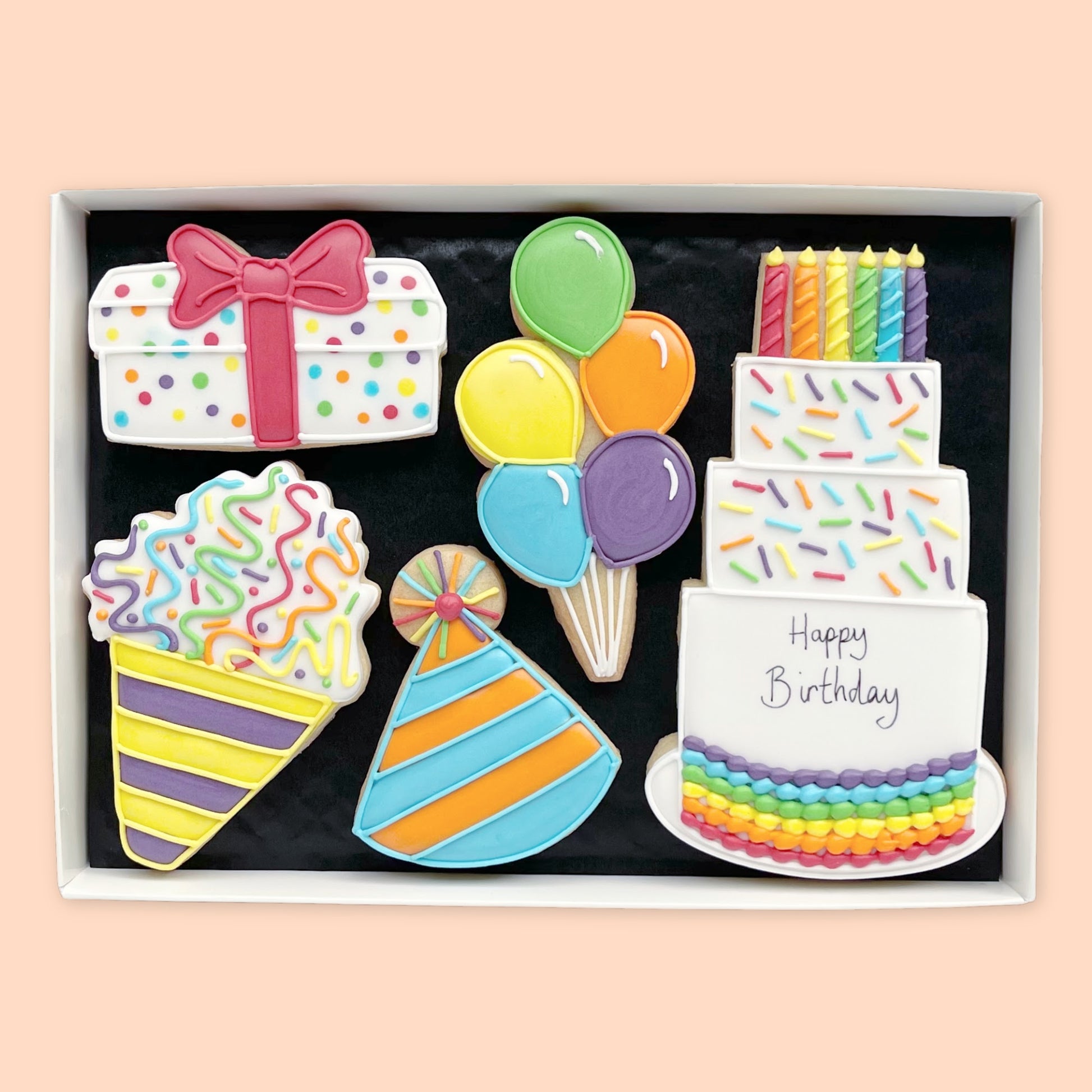 Hand Iced Birthday themed biscuits in an open white gift box by Katie's biscuit shop
