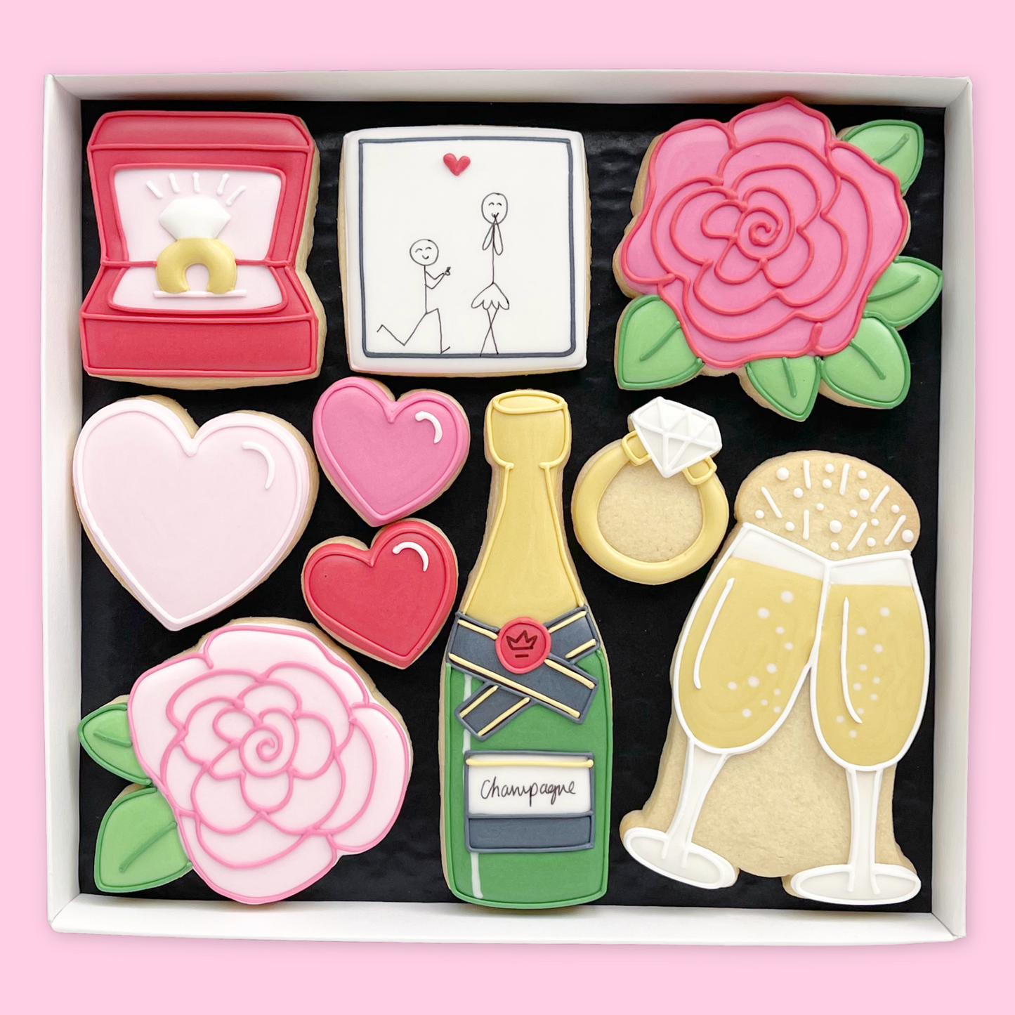 Hand Iced Engagement themed biscuits in an open white gift box by Katie's Biscuit Shop